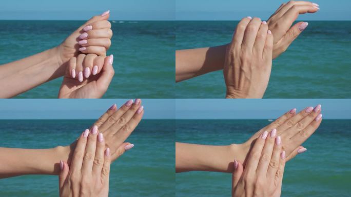 女性的手与美丽的自然粉红色优雅的美甲。