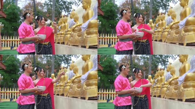 年轻夫妇在泼水节期间穿着传统的泰国服装。