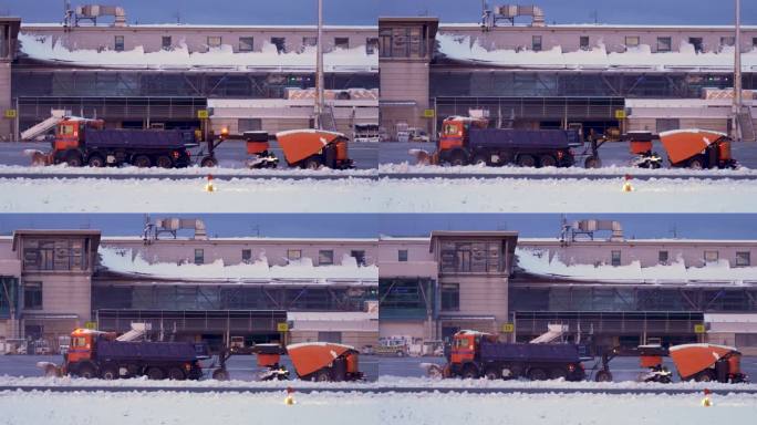 扫雪车在国际机场航站楼和跑道清理积雪