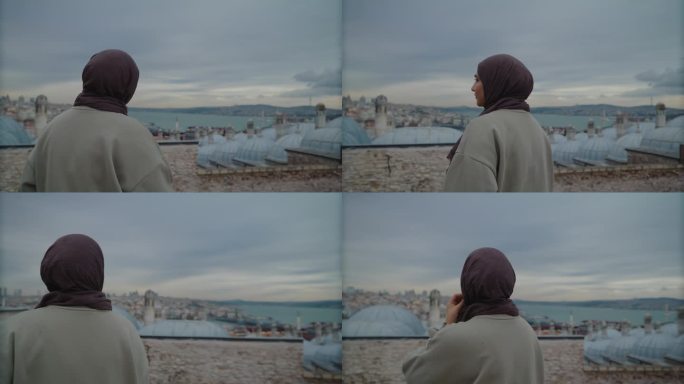 WS城市宁静:戴头巾的妇女在屋顶上凝视伊斯坦布尔的天际线#Istanbul -远景#Cityscap