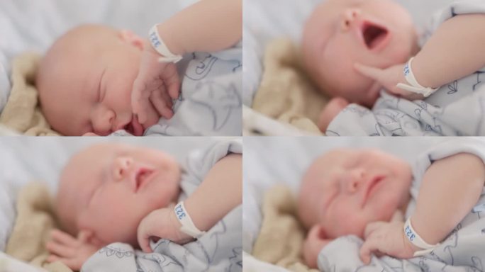 新生儿在产科病房的婴儿床上睡觉时伸展和打哈欠的特写镜头