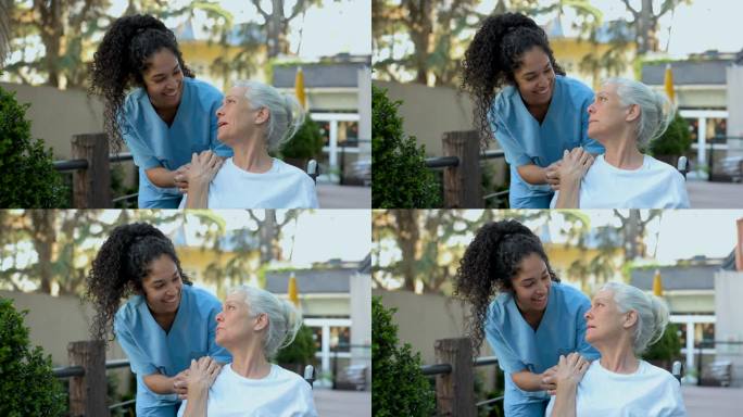 在辅助生活设施中，关怀的护士与女老年病人手牵着手，两人愉快地交谈