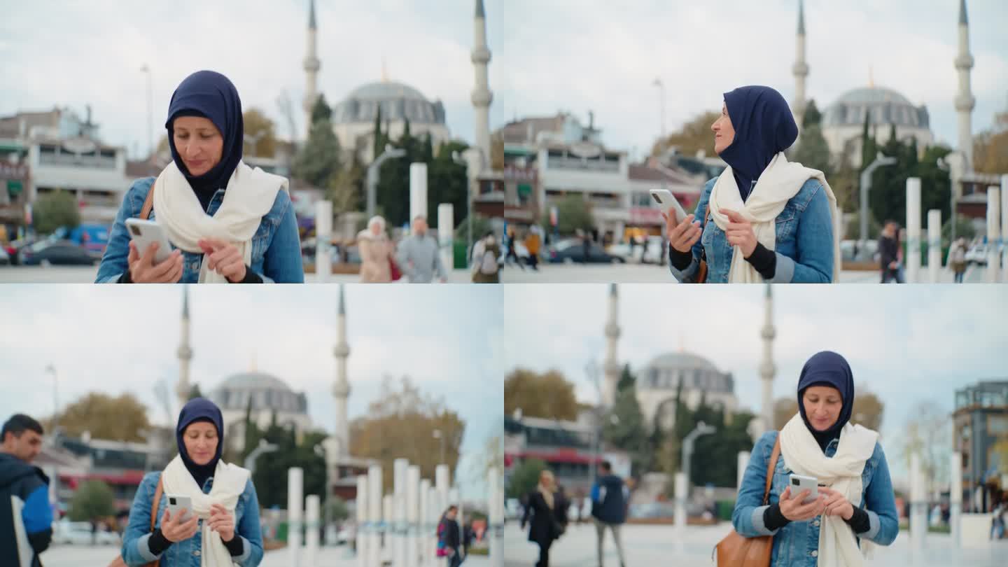 女游客在伊斯坦布尔一座清真寺前行走时使用智能手机#清真寺连接#数字沉思#伊斯兰反思