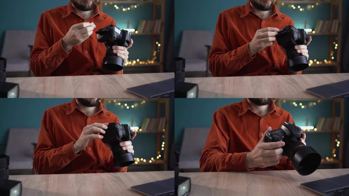 摄影师在他的家庭办公室插入或取出专业相机的存储卡的特写。