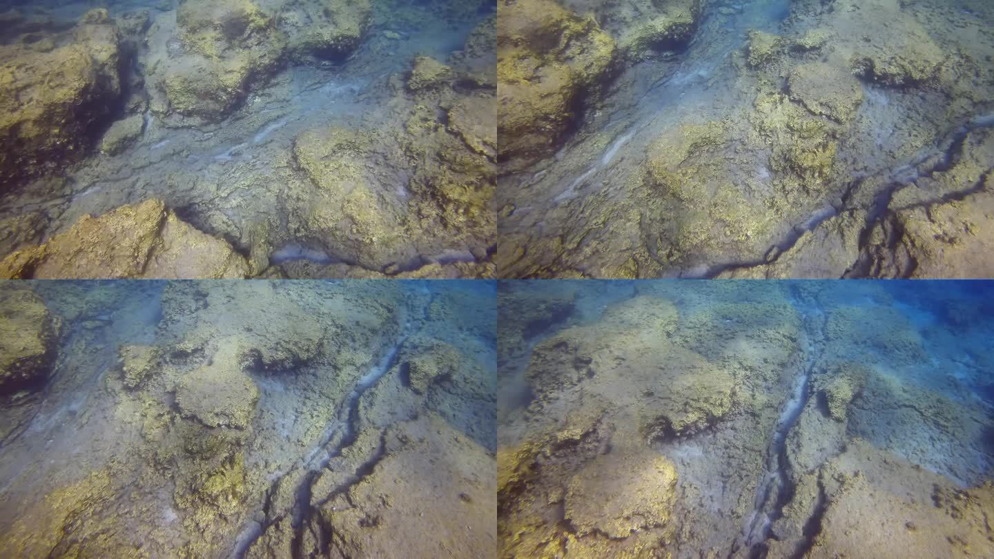 俯视图，覆盖着裂缝的海底岩板的特写全景