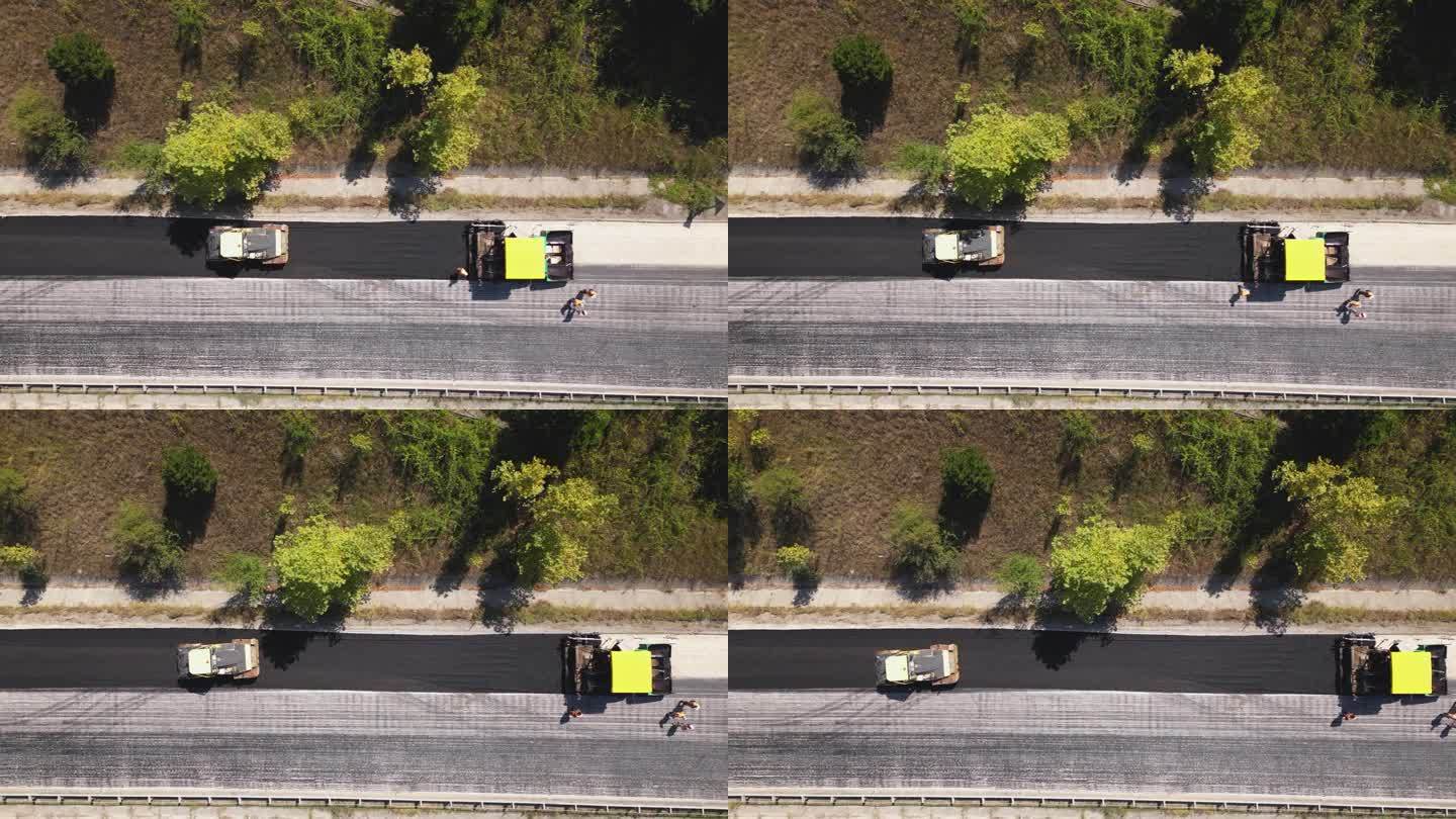 圆柱形滚筒车沥青路面鸟瞰图。双线公路的道路养护工作。