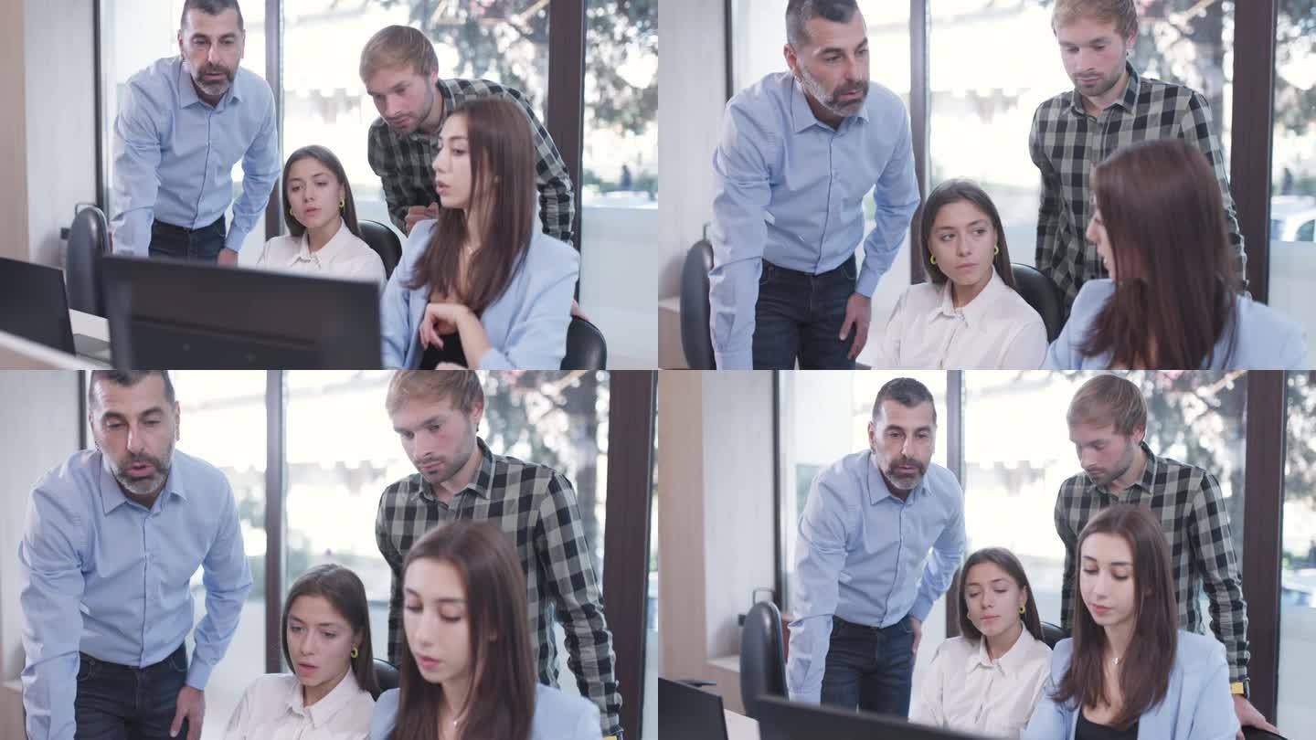 成功的商业团队在办公室工作。在电脑屏幕前进行头脑风暴和提供建议。同事解决工作任务问题。