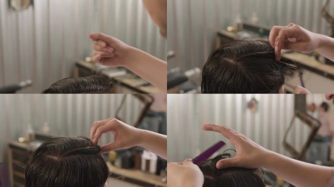 理发师用梳子将顾客的湿发分开