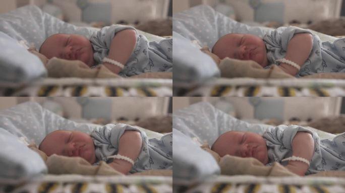 可爱的新生男婴在妇产医院的婴儿床上睡觉的特写镜头。一个5天大的婴儿