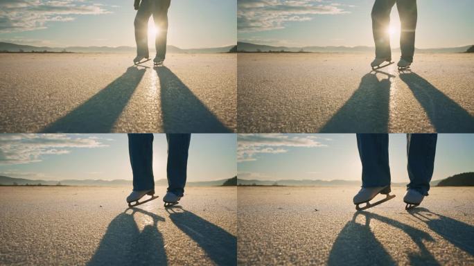 日出时，穿着溜冰鞋的年轻女子站在冰冻的湖面上