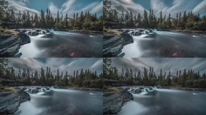 一个长曝光视频的浅山河与一个小瀑布。变化的云在上空飞翔。