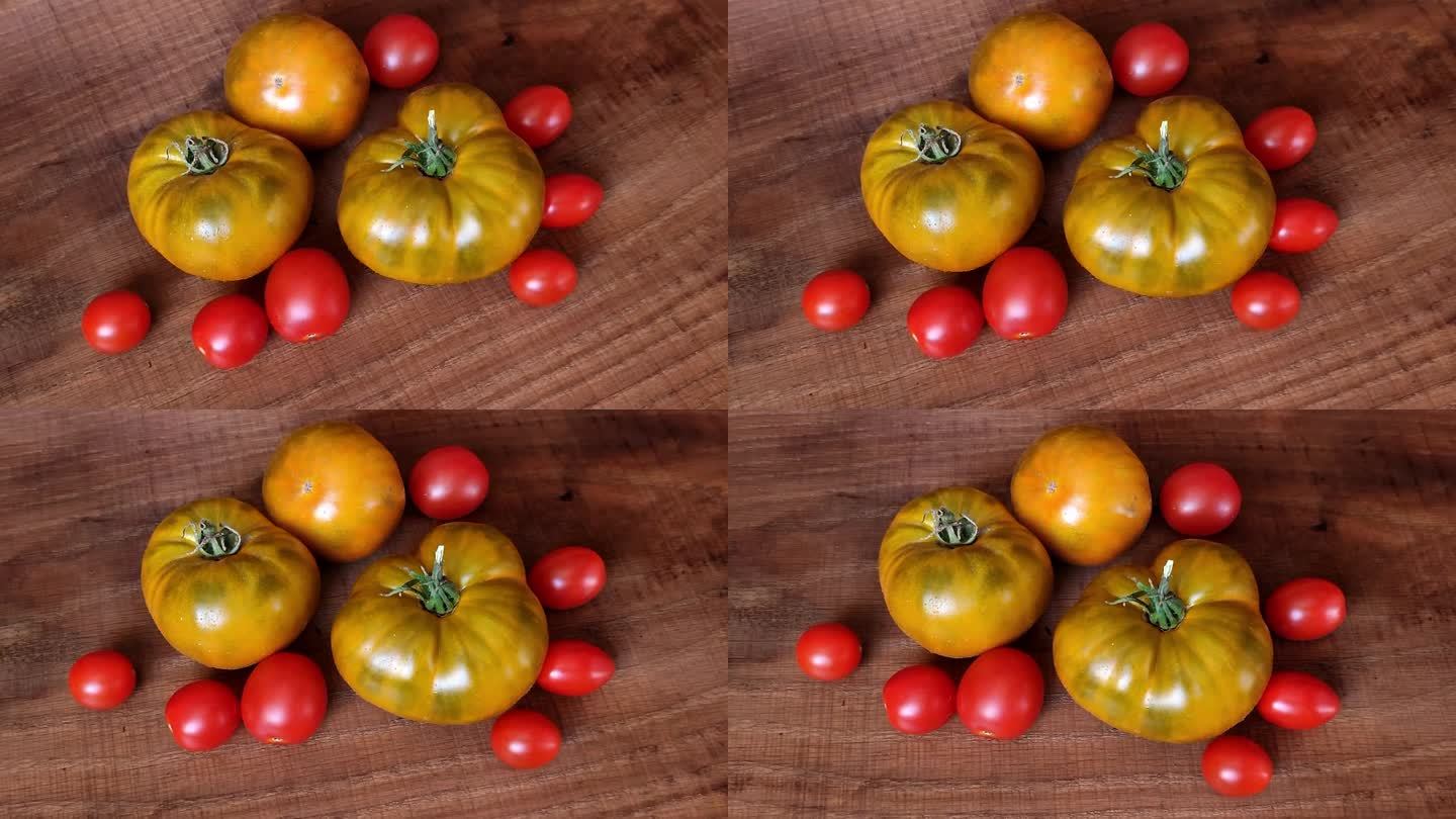五颜六色的牛肉红绿黄和樱桃农民新鲜的生态番茄在木桌的背景。