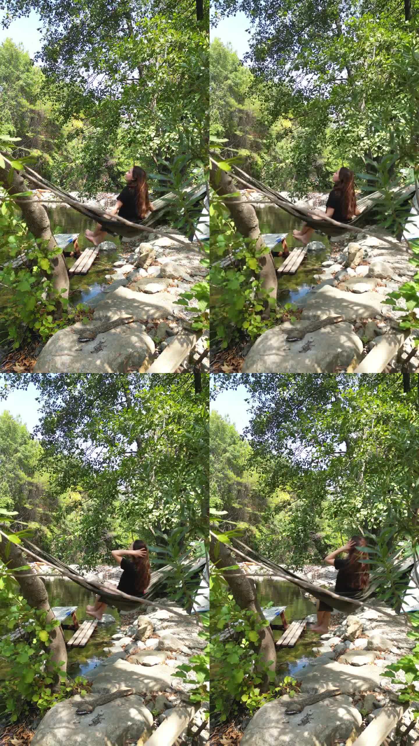 热爱大自然的年轻女性，在密林的溪边，在吊床上摇曳，倾听着大自然的声音。她转过身去。