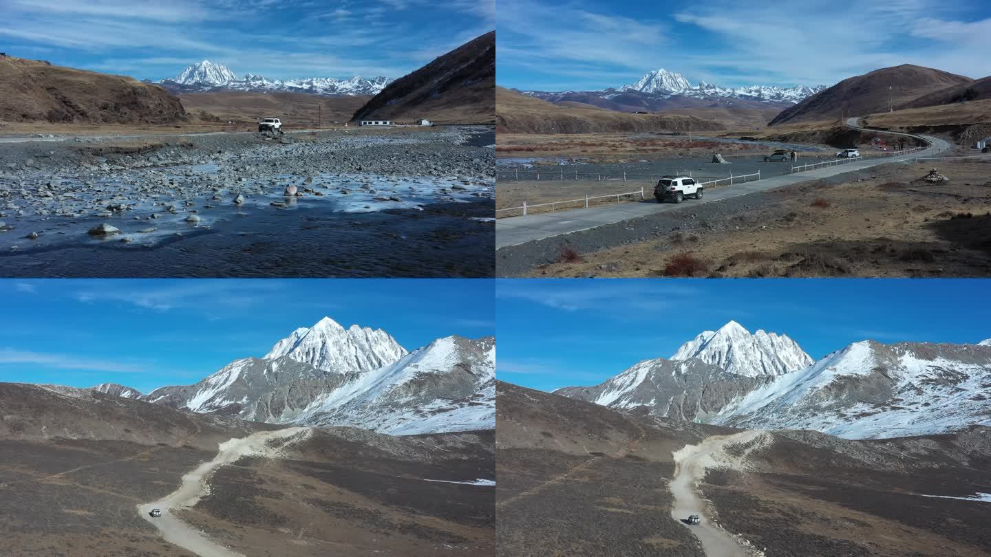 越野车行驶在雪山脚下