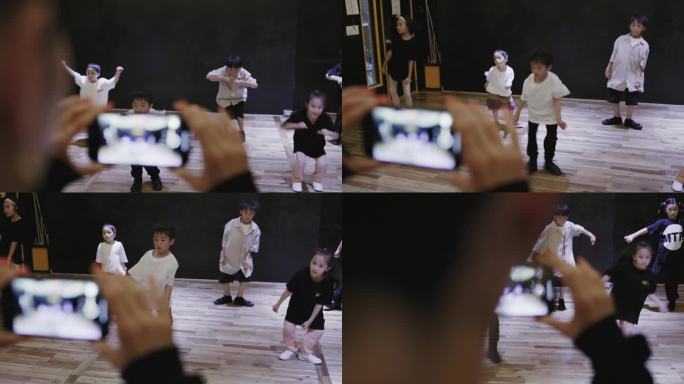 骄傲的日本嘻哈老师用智能手机拍摄学生跳舞的视频