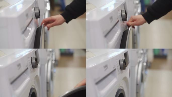 一个白人男子的手在调节洗衣机的旋钮
