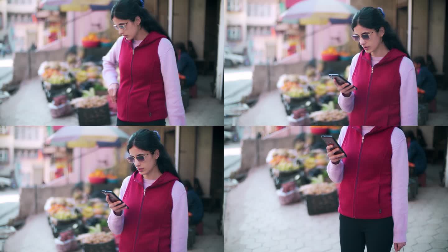 一名女子在一家蔬菜水果店购物后查看她的智能手机。