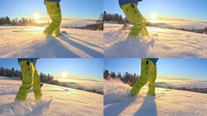 镜头:在金色的冬日日出中，滑雪板运动员和他的狗一起骑着粉雪