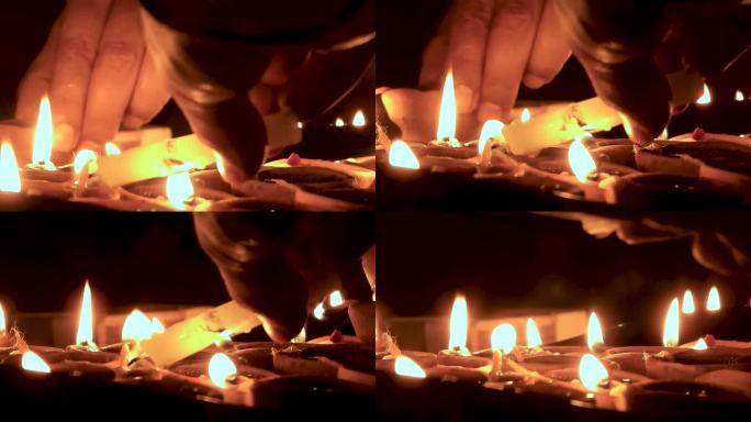 排灯节照明:手在北阿坎德邦点亮陶罐的特写，印度-电影镜头
