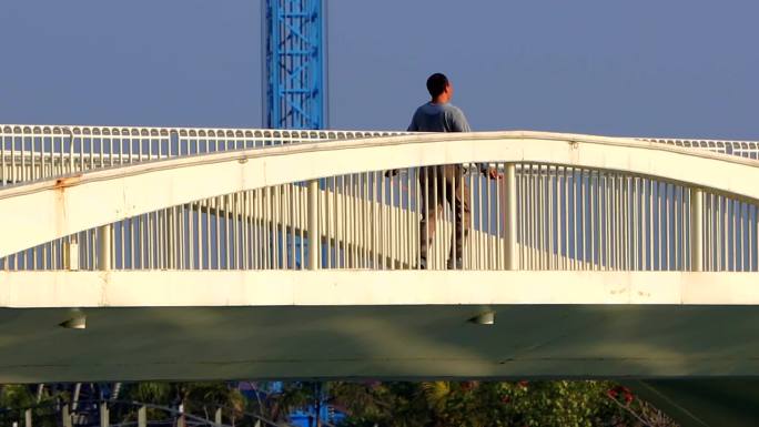 清晨海边人行桥上中年大叔妖娆地跳绳