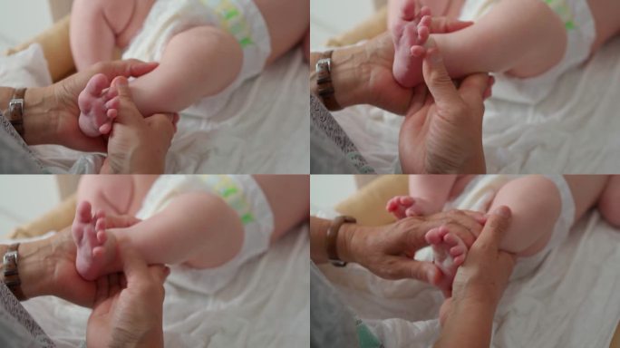 女性用手揉脚，按摩婴儿小脚的脚底和脚后跟