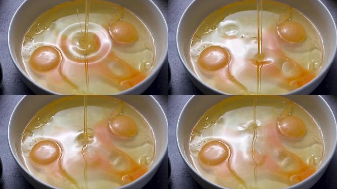 将油倒入蛋液中。做煎蛋卷，早餐或烘焙。蛋白质食物