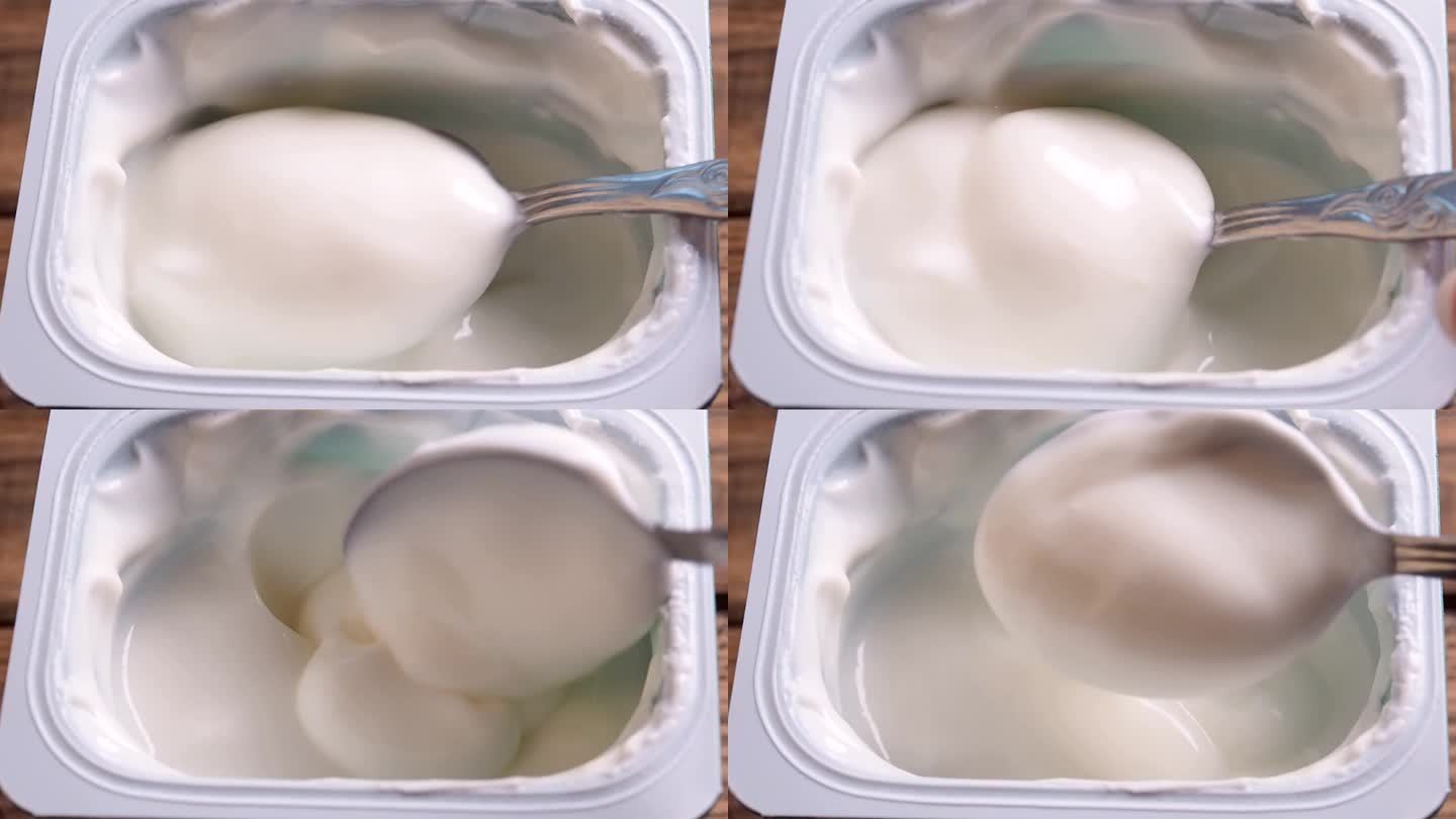用勺子搅拌酸奶的特写，乳制品。