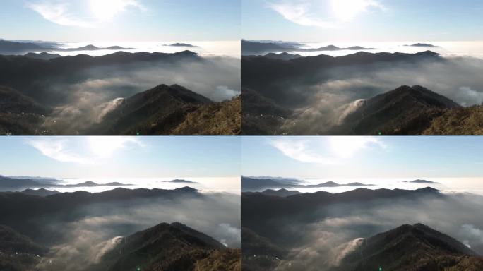 在利古里亚的热那亚，日出时云雾缭氲的山峰浮现在云层之上