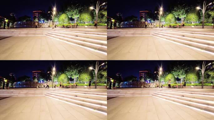 夜晚广场玩滑板车的年轻人