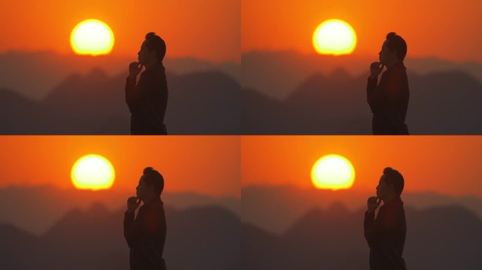 黄昏日落男人站在山顶思考冥想人生未来理想