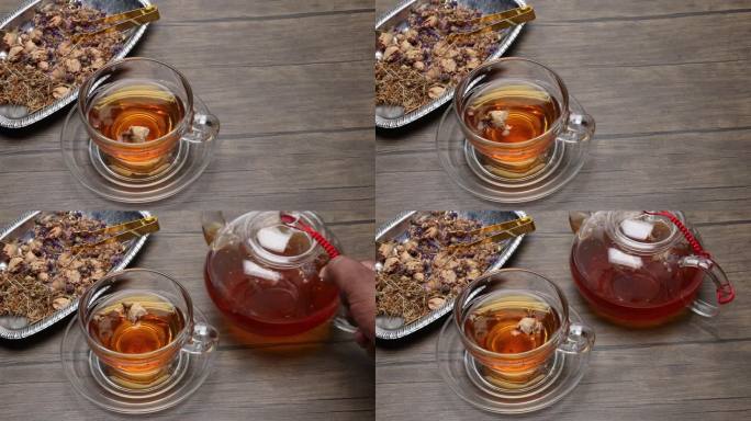 制作和倒花草茶饮透明玻璃茶壶到茶杯扭拿放在质朴的木桌