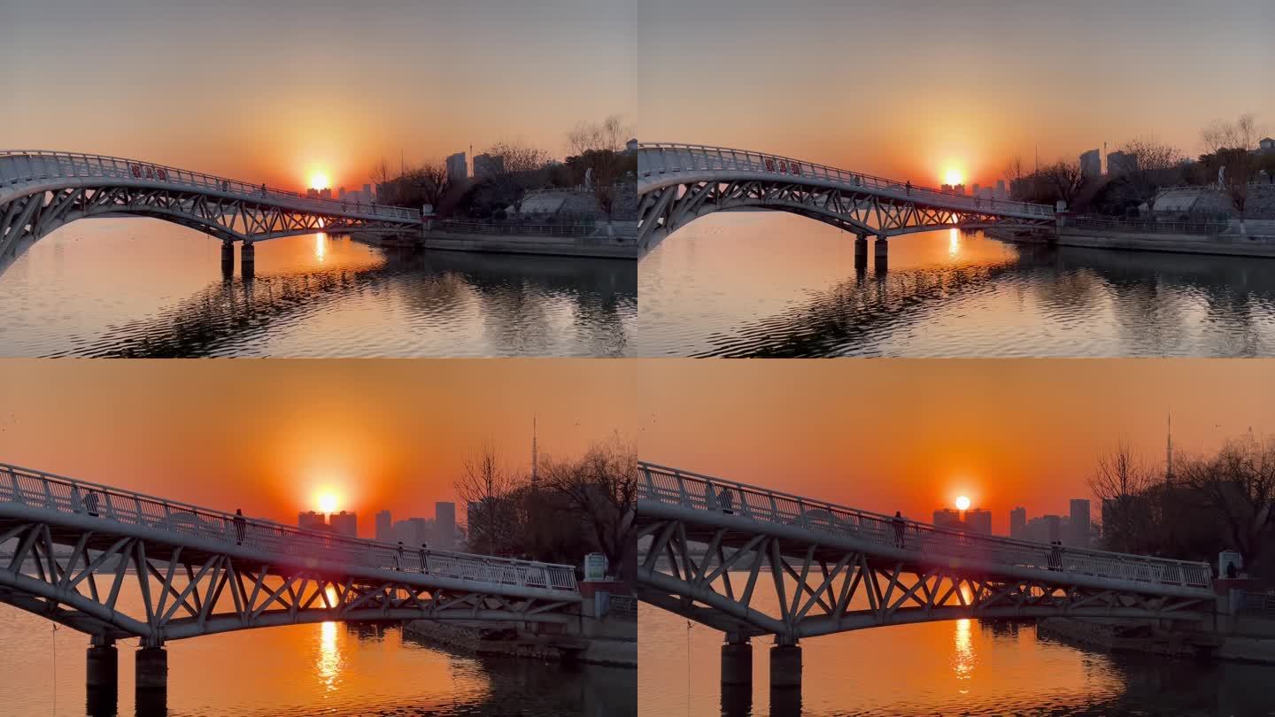 落日余晖铁架桥河流散步的人变焦