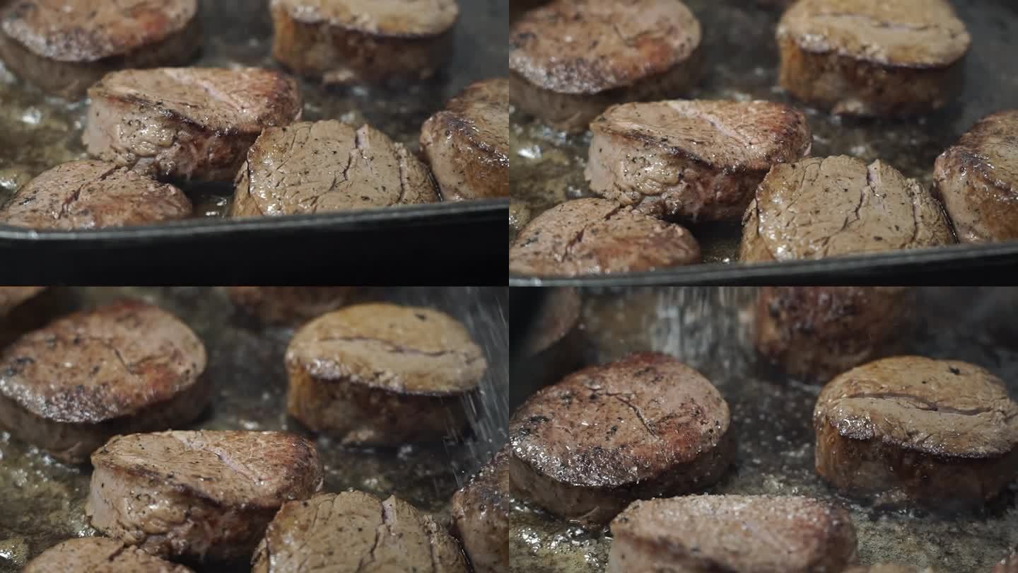 在煎牛肉上撒盐。做牛排。特写镜头