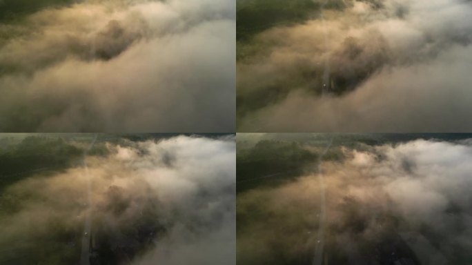 公路上的山鸟瞰在天空之上的云和移动的雾