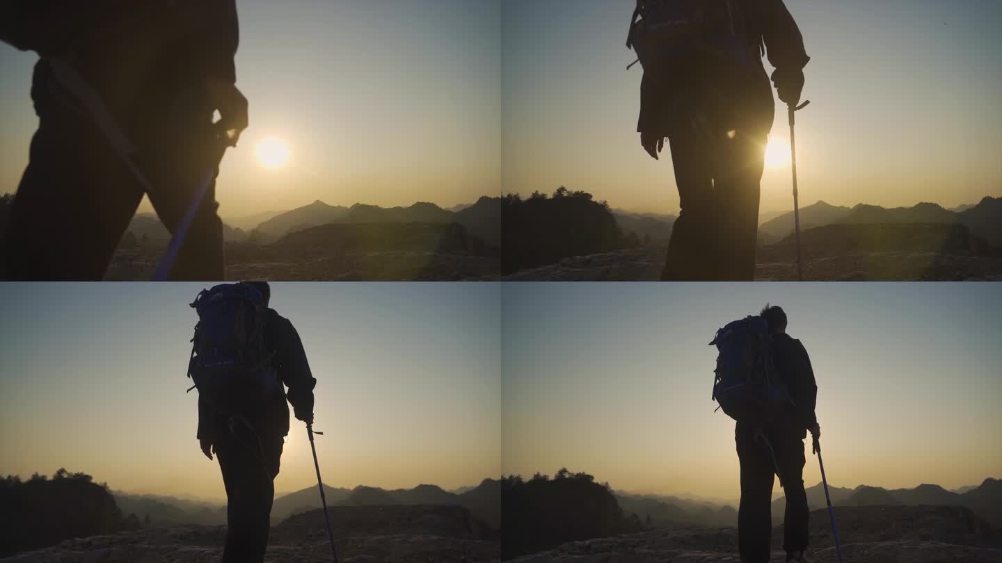 背着登山包男人山顶逆光行走背影走向山顶