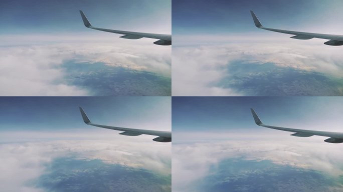 Airplane wing flying high above the clouds in a cl