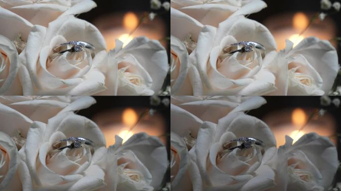 新娘捧花上的白玫瑰花瓣中间夹着两枚白金结婚戒指。婚礼的细节