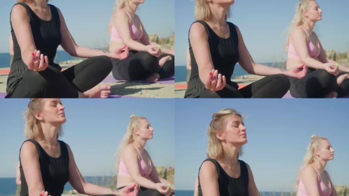 女性在海边享受阳光，坐在瑜伽垫上做莲花式冥想。