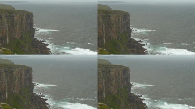 在刮风的天气里，成群的海鸟盘旋在岩石峭壁上寻找栖息之处