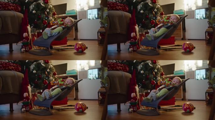 在家客厅装饰圣诞树的背景下，小男孩在保镖上摇摆的SLO MO锁定镜头