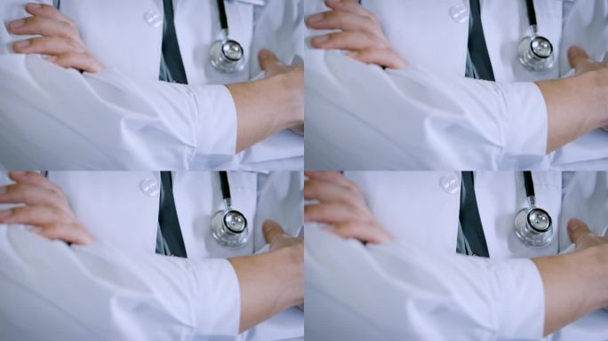 医生带着听诊器。医生的白大褂自信地站在那里，双臂交叉。值得信赖的医生和健康保险的概念