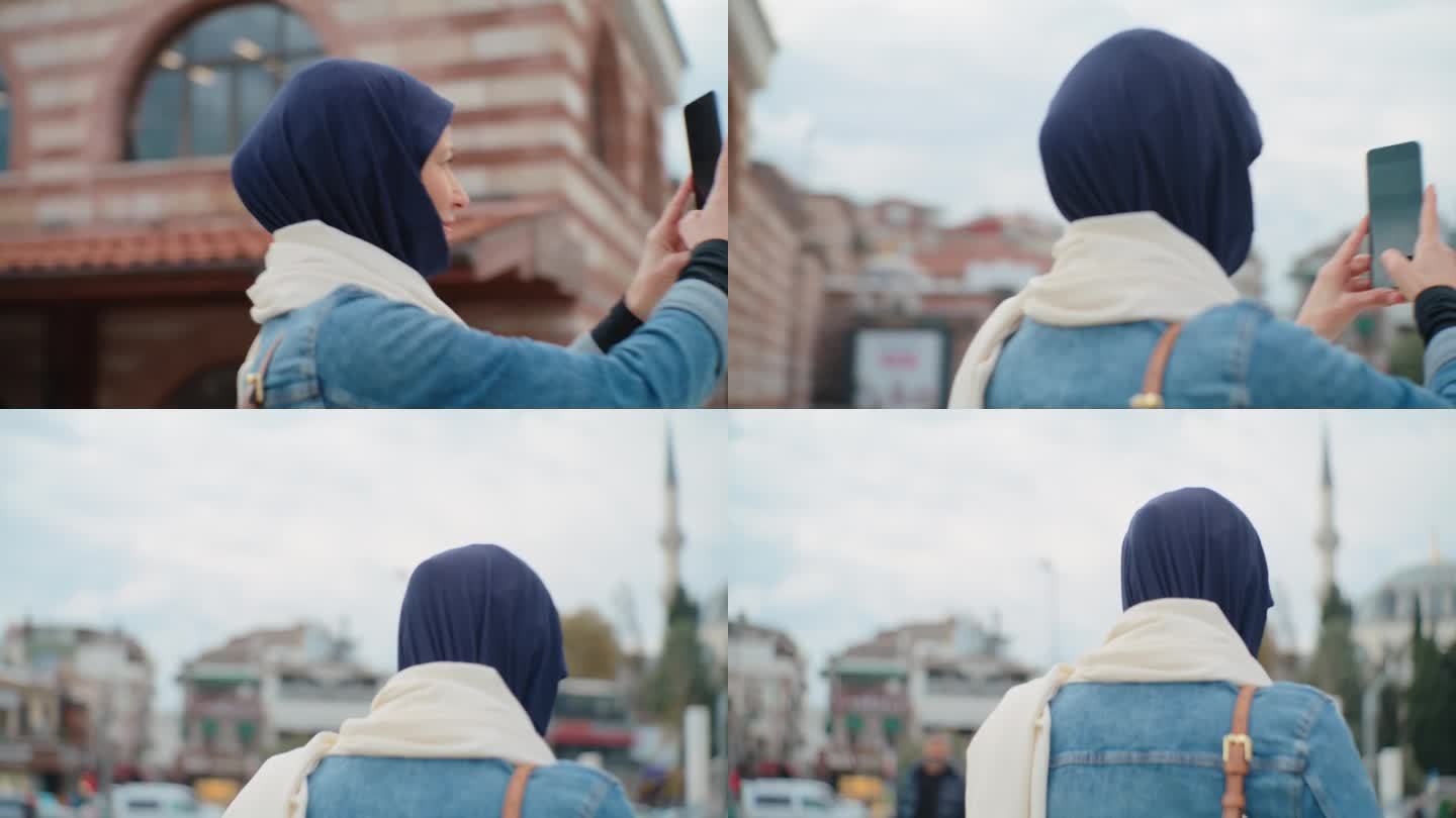 一位女游客用她的智能手机在伊斯坦布尔的清真寺拍照#清真寺连接#数字沉思#伊斯兰反思