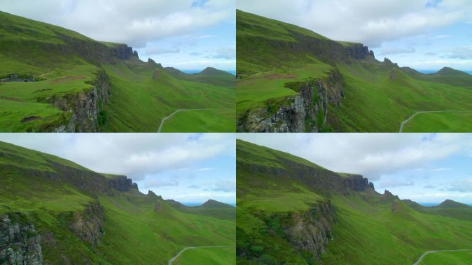航拍:基岭的绿色草坡被陡峭的岩石悬崖交叉