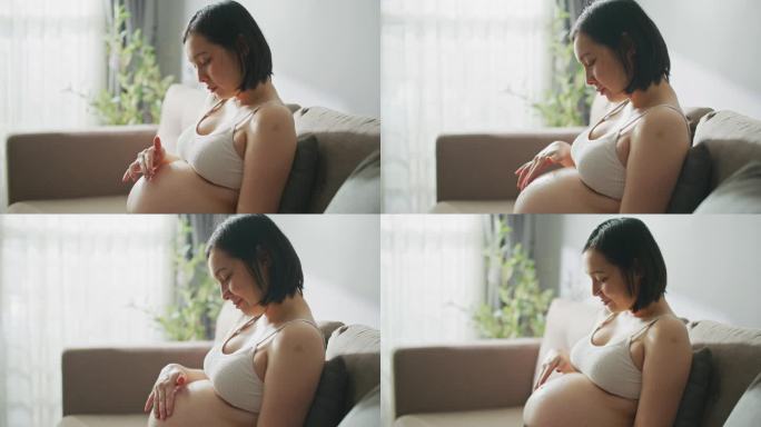 孕妇在家给肚子涂润肤霜的跟踪镜头