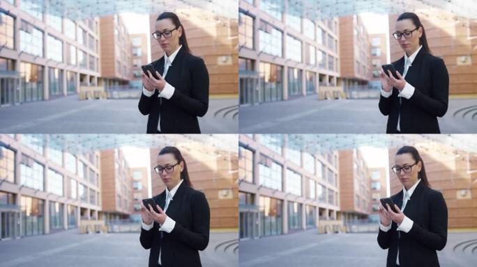 白人女商人在大城市街道上使用智能手机的肖像。自信的管理者在工作休息时间上网、发信息、上网