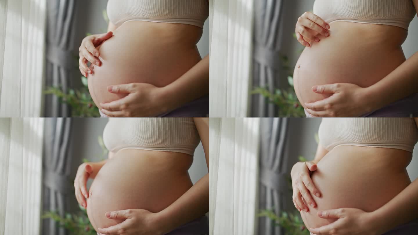 孕妇腹部特写。拥抱和抚摸
