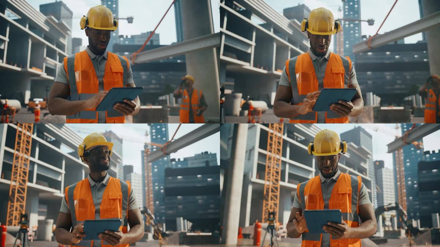 一个英俊的黑人土木工程师在建筑工地的平板电脑上工作的肖像。非洲青年站在户外，使用电脑设备规划和开发房