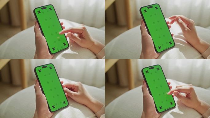一个女人用绿屏智能手机