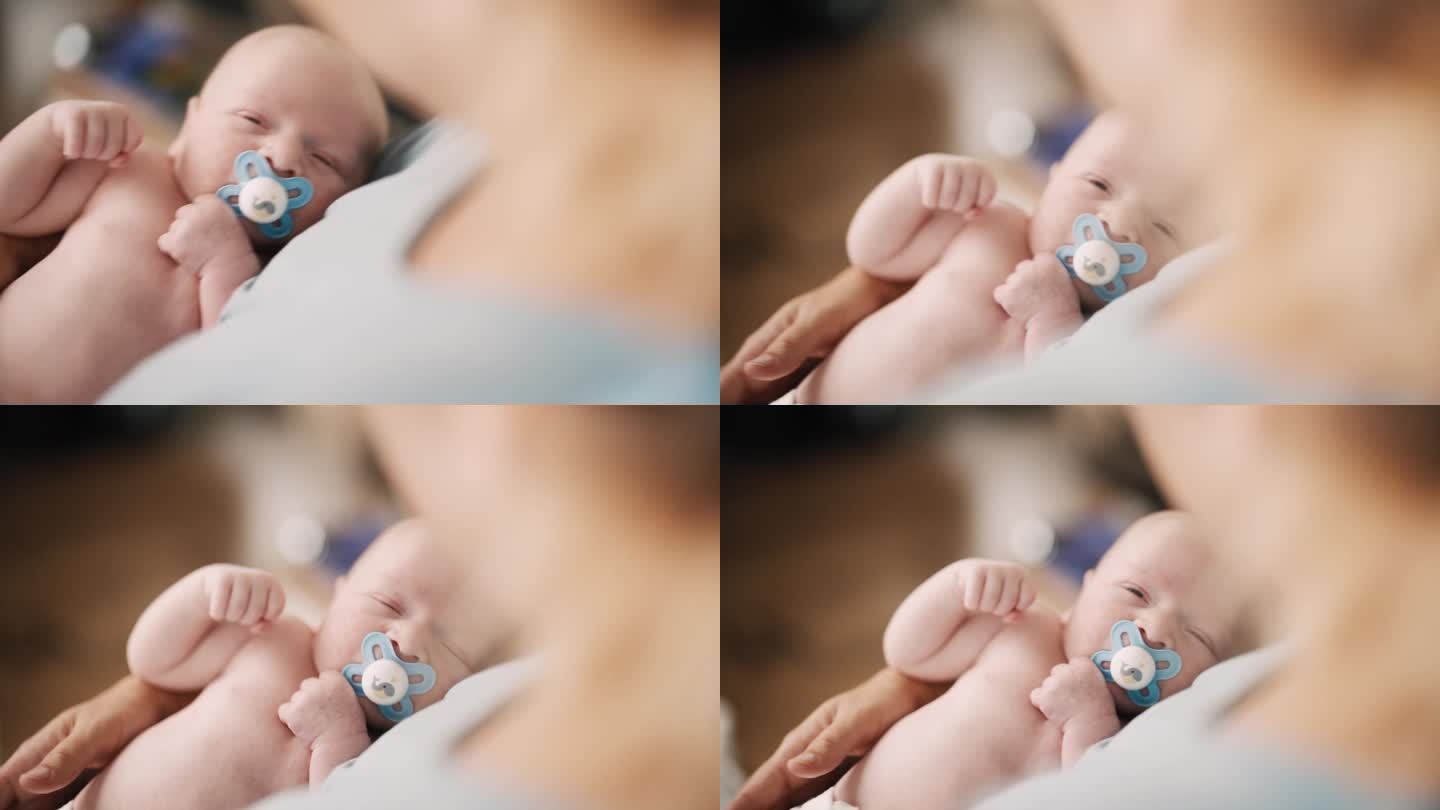 SLO - MO高角度拍摄的母亲在家里把婴儿抱在怀里睡觉