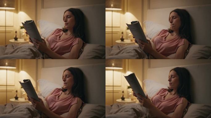 酷女孩在床上看书特写。放松的女人睡前喜欢看小说